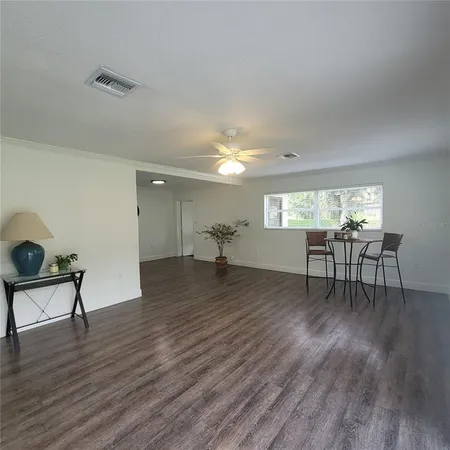 a view of a livingroom with furniture wooden floor and windows