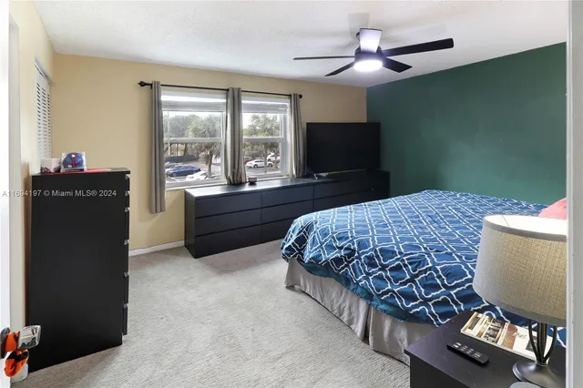 a bed room with a bed and a television