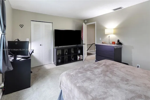 a bedroom with furniture and flat screen tv