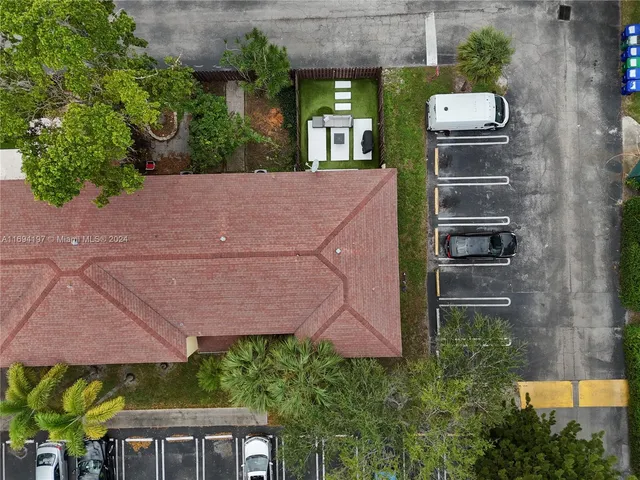 an aerial view of a house with garden space and street view