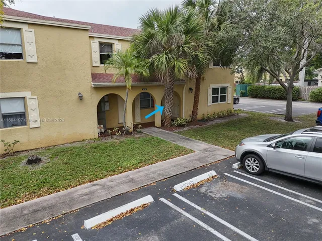an aerial view of a house with garden space and street view
