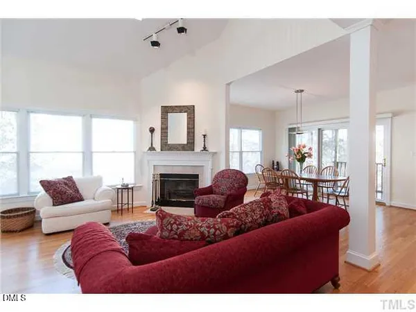 a living room with furniture a fireplace and a large window