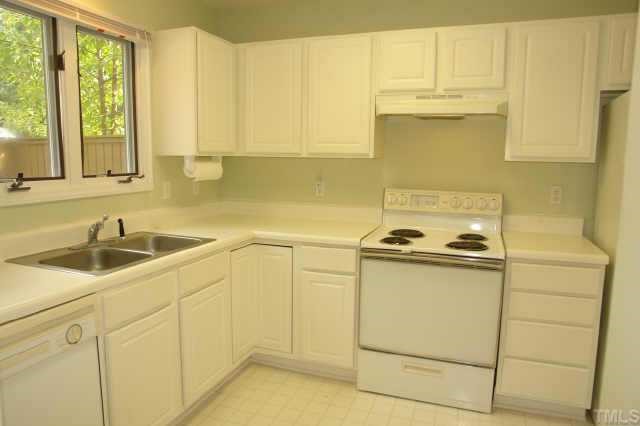 4211 Sunshadow Lane Raleigh, NC 27613 - Photo 2 of 10 a kitchen with a sink and cabinets