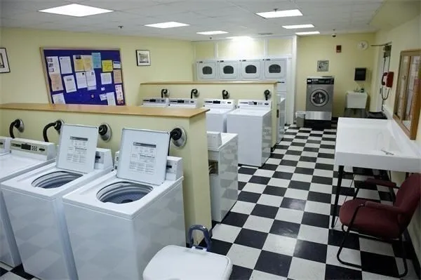 a kitchen with stainless steel appliances a sink a stove a refrigerator and cabinets