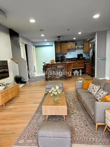 a living room with furniture and kitchen view