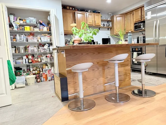 a kitchen with stainless steel appliances granite countertop a sink and a refrigerator