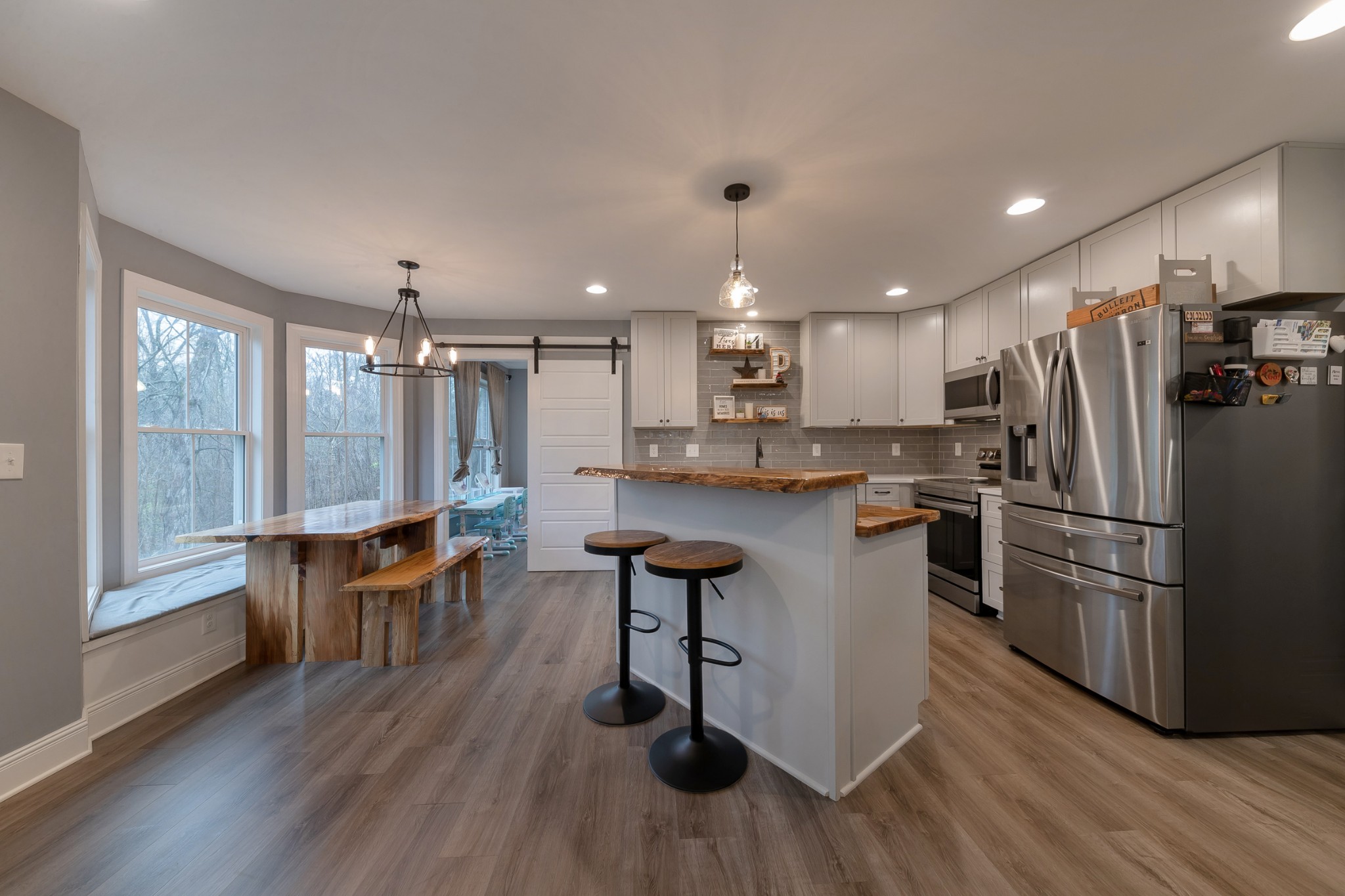 7452 South Swift Road Goodlettsville, TN 37072 - Photo 11 of 37 a kitchen with stainless steel appliances granite countertop a refrigerator a stove a sink dishwasher and white countertops with wooden floor