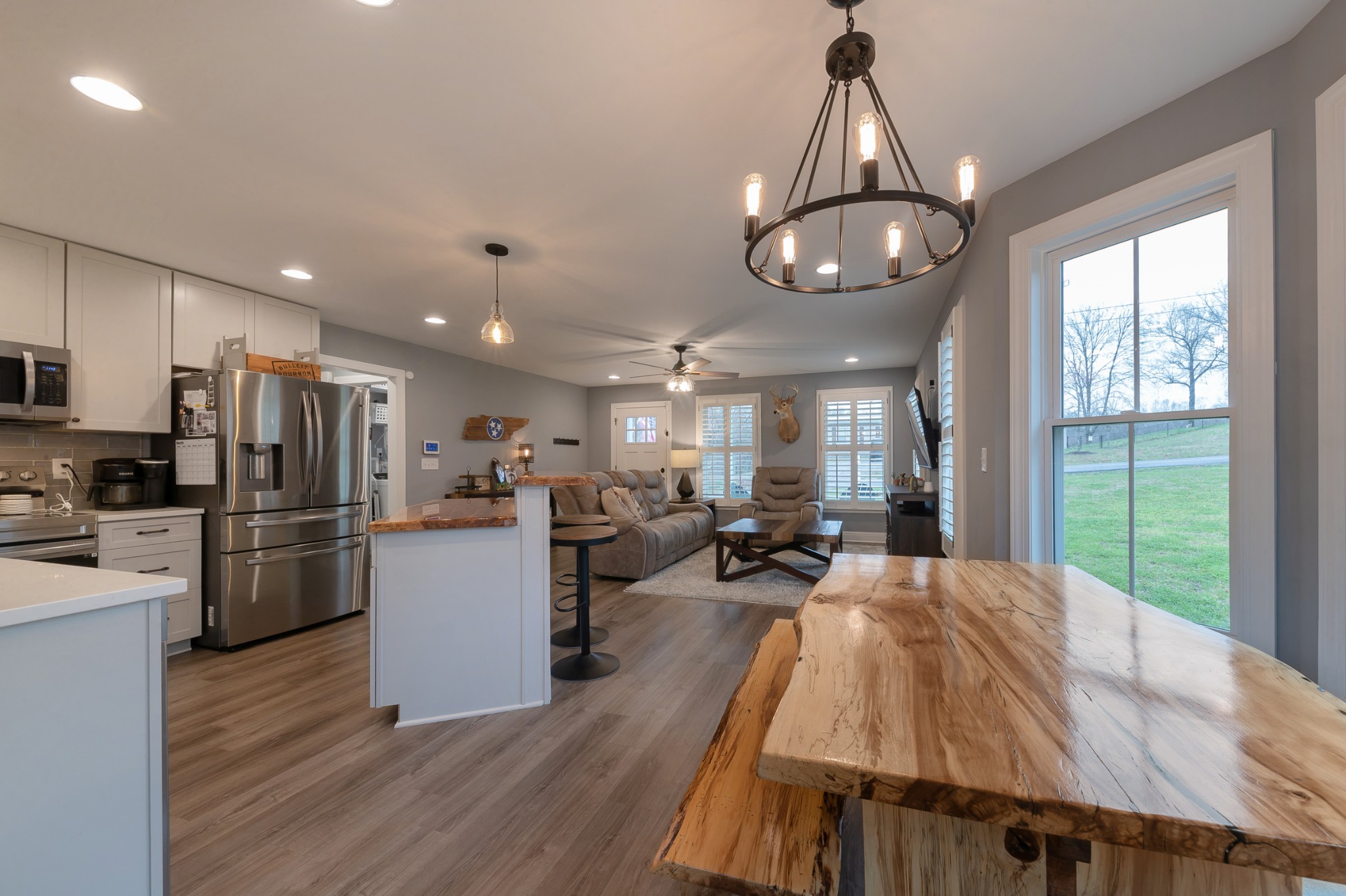 7452 South Swift Road Goodlettsville, TN 37072 - Photo 16 of 37 a view of a dining room with furniture a chandelier and wooden floor
