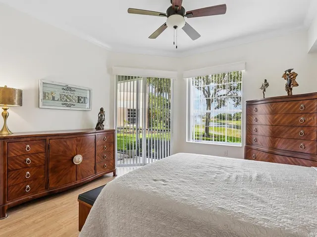 a bedroom with a bed dresser and a window