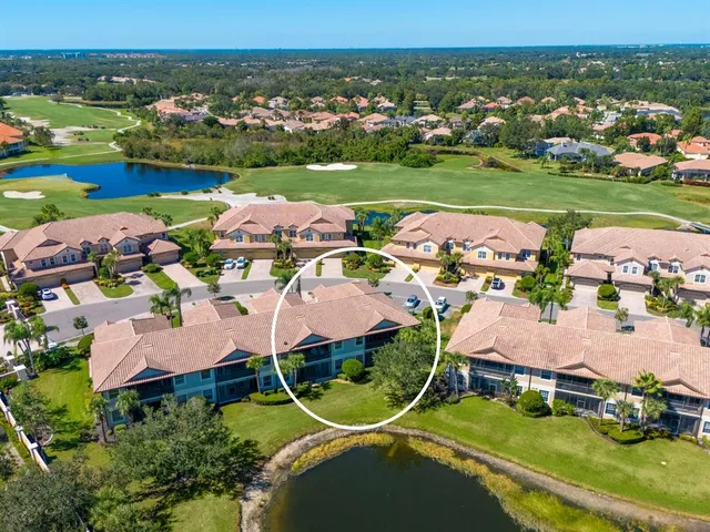 an aerial view of residential houses with outdoor space and river
