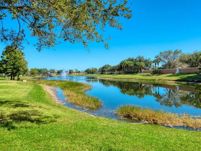 an aerial view of ocean and residential houses with outdoor space