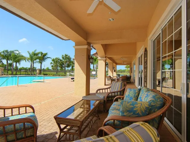 a dining room with furniture and a floor to ceiling window