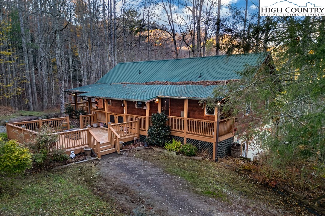 an aerial view of a house with swimming pool and wooden fence