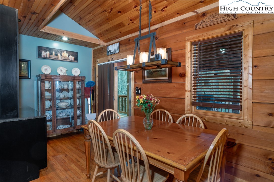 2417 Russell Norris Road Elk Park, NC 28622 - Photo 8 of 22 a view of a patio with table and chairs with wooden floor