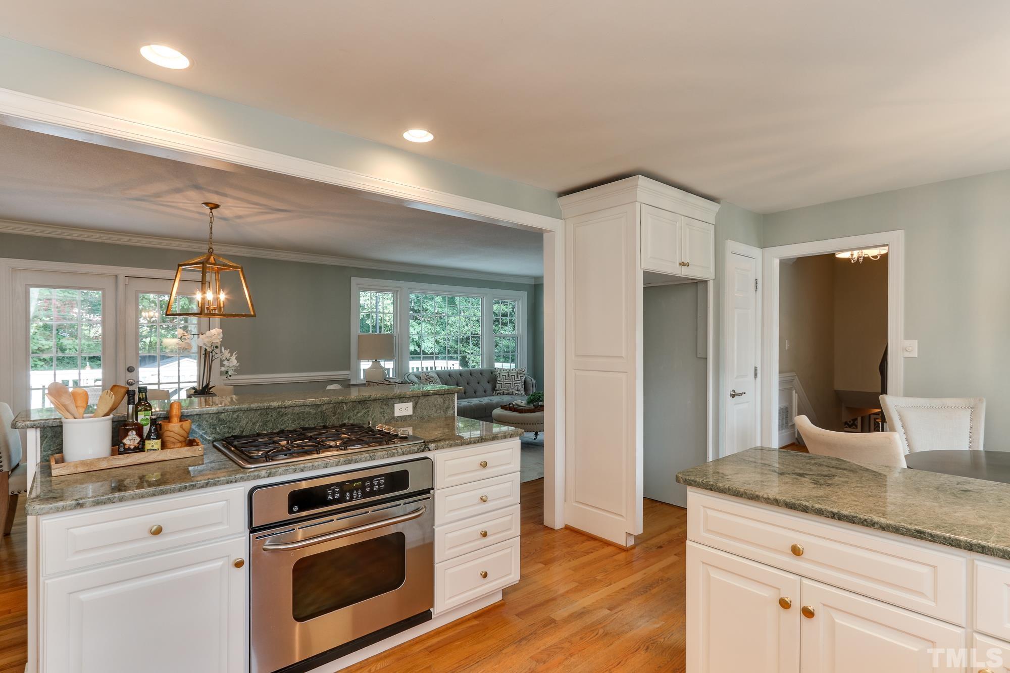 4804 Rampart Street Raleigh, NC 27609 - Photo 11 of 27 a kitchen with stainless steel appliances granite countertop a stove and a sink