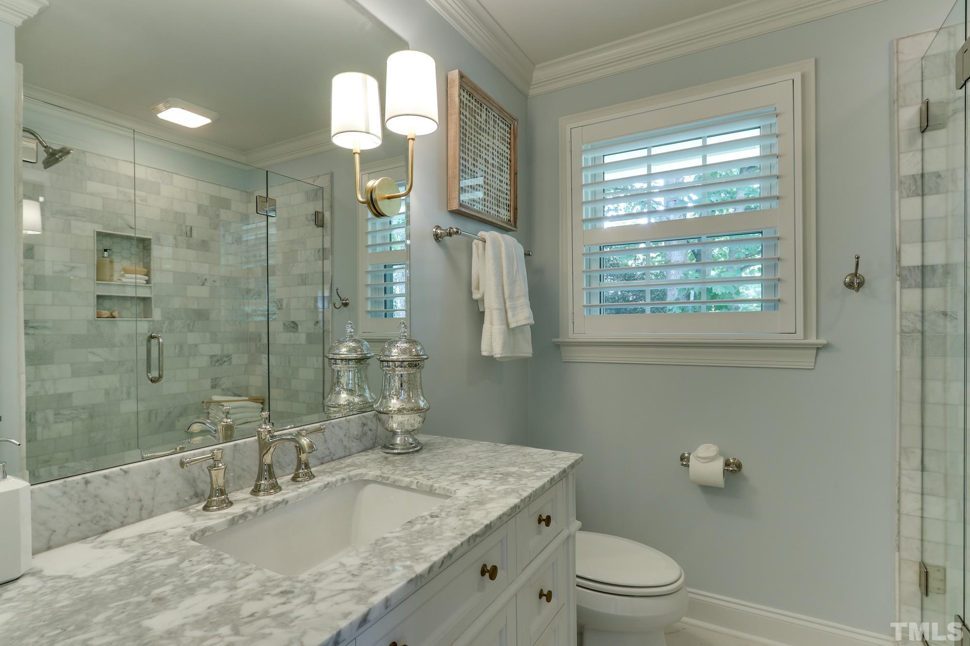 4804 Rampart Street Raleigh, NC 27609 - Photo 15 of 27 a bathroom with a granite countertop sink a toilet and shower