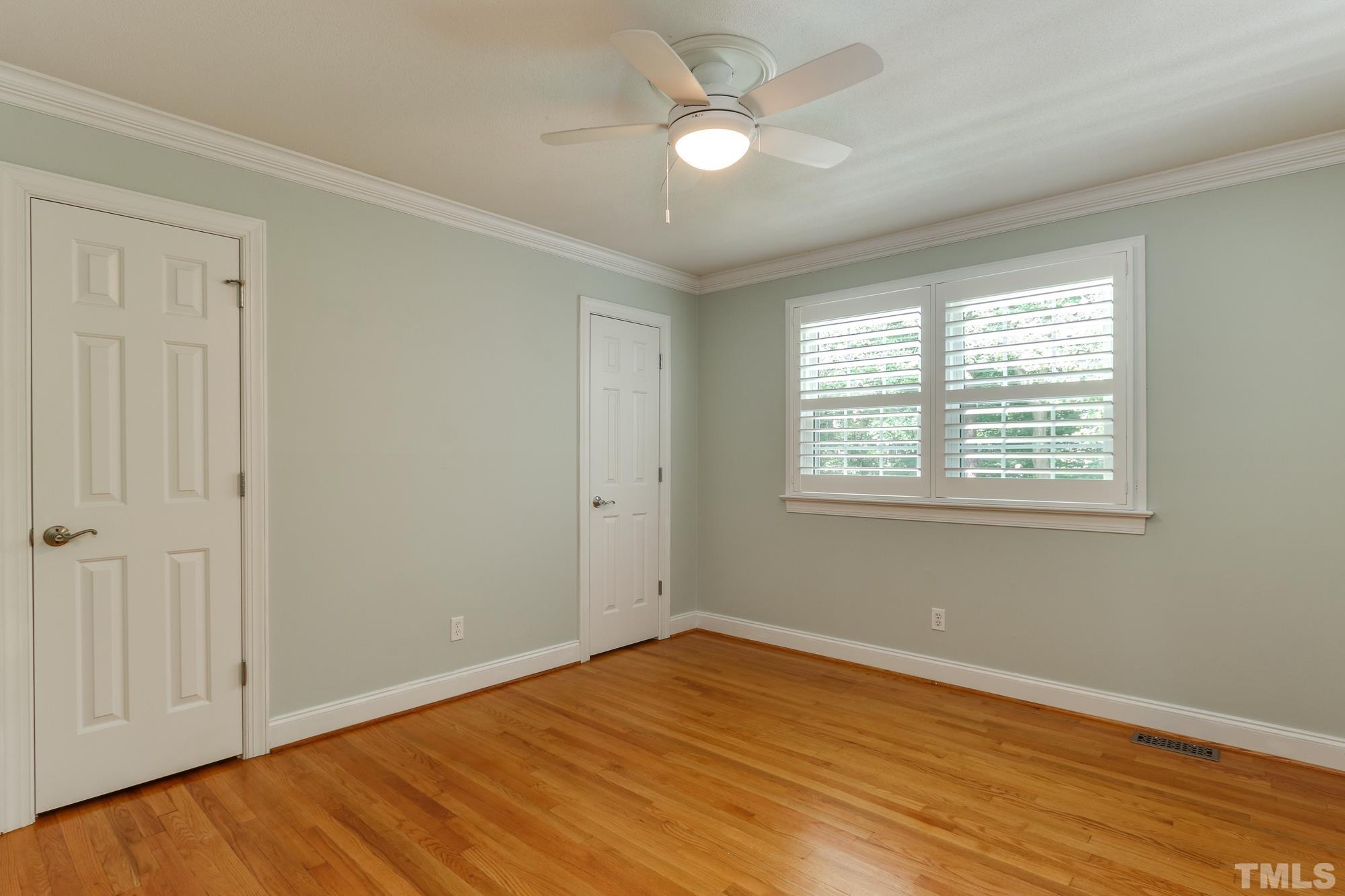 4804 Rampart Street Raleigh, NC 27609 - Photo 17 of 27 wooden floor in an empty room with a window