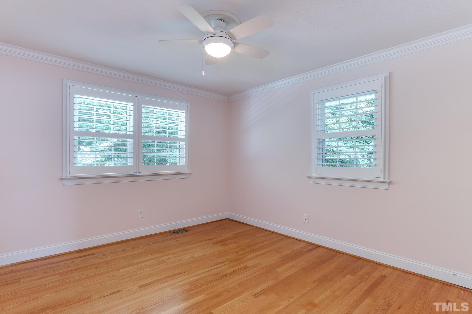 4804 Rampart Street Raleigh, NC 27609 - Photo 19 of 27 a view of empty room with wooden floor and fan