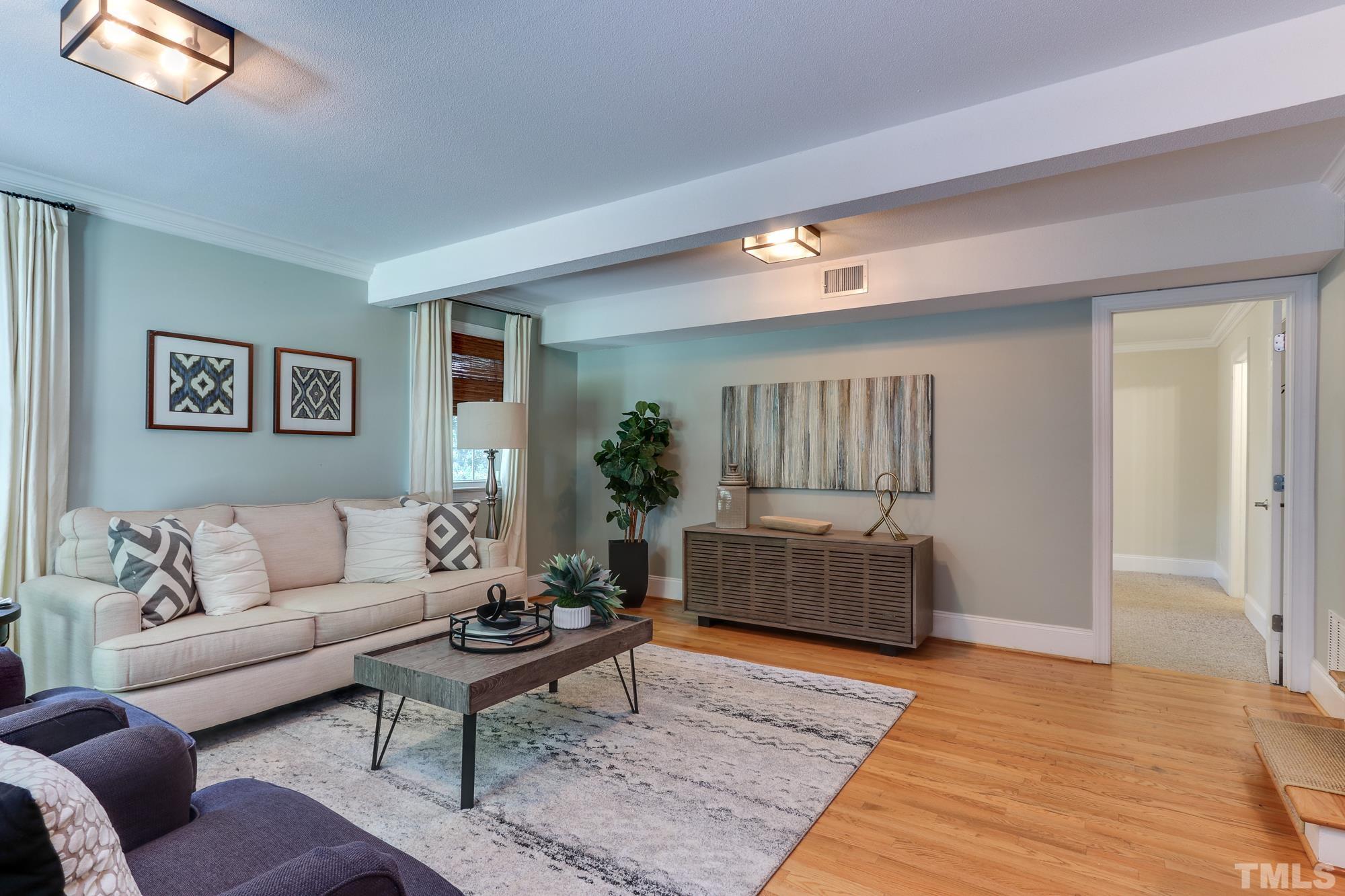4804 Rampart Street Raleigh, NC 27609 - Photo 21 of 27 a living room with furniture and a wooden floor
