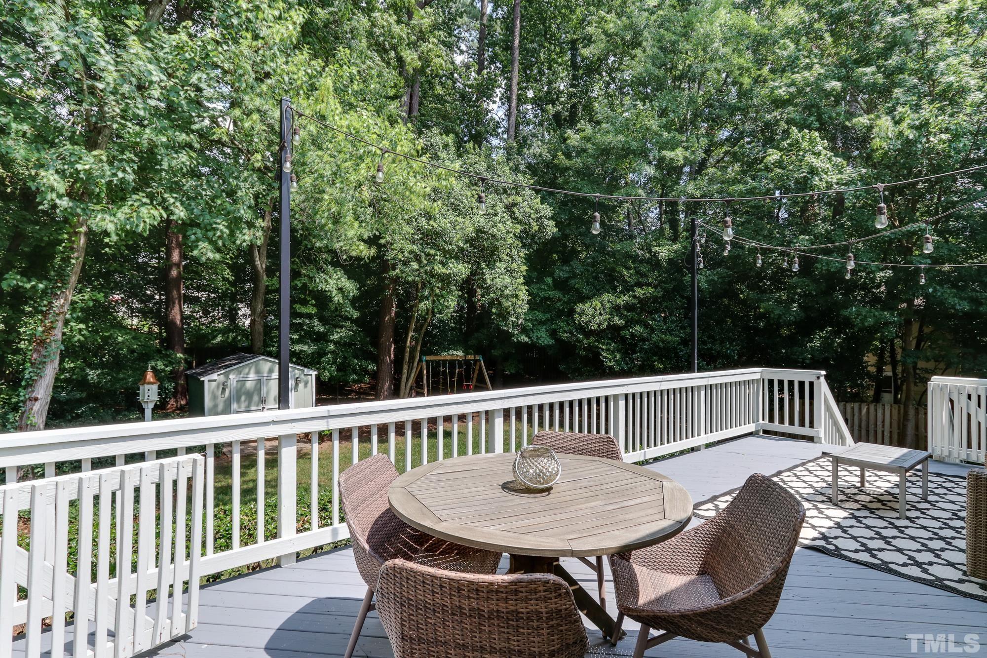 4804 Rampart Street Raleigh, NC 27609 - Photo 24 of 27 a view of a dining table and chairs on the roof deck