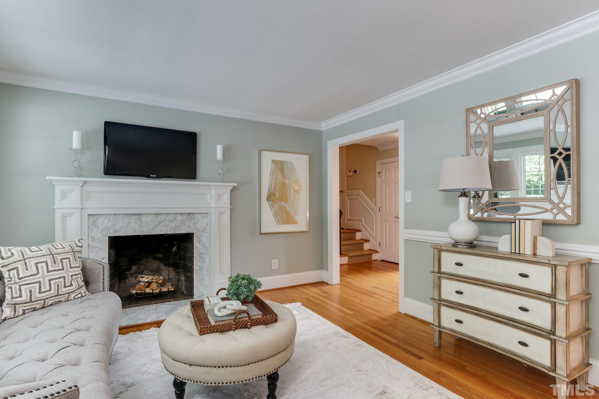 4804 Rampart Street Raleigh, NC 27609 - Photo 5 of 27 a living room with furniture and a fireplace