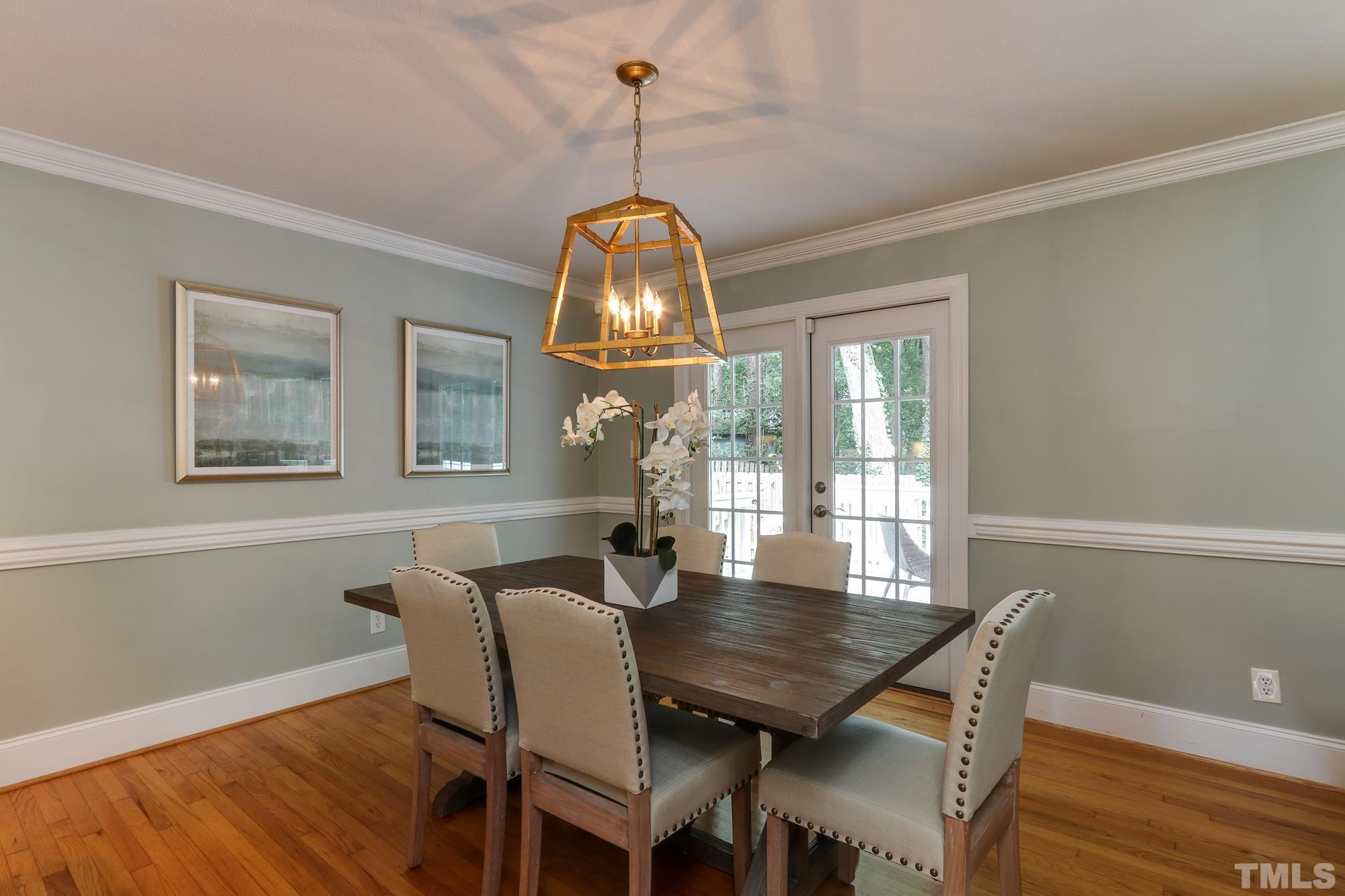 4804 Rampart Street Raleigh, NC 27609 - Photo 7 of 27 a view of a dining room with furniture window and wooden floor