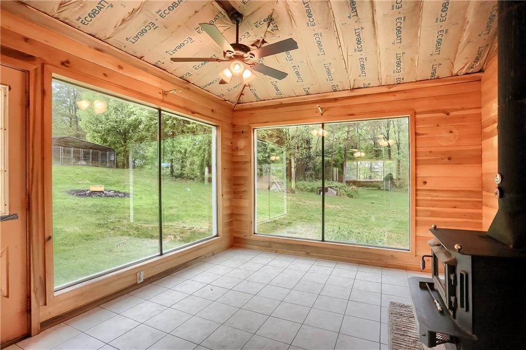 This sitting room offers plenty of natural light and brings the outdoors in--open to the kitchen, this space could serve a variety of functions. 