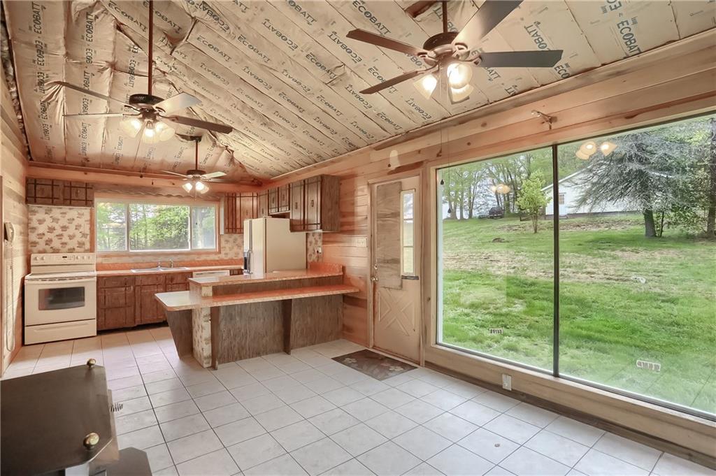 323 Boyers Road Harrisville, PA 16038 - Photo 8 of 25 This sitting room offers plenty of natural light and brings the outdoors in--open to the kitchen, this space could serve a variety of functions.
