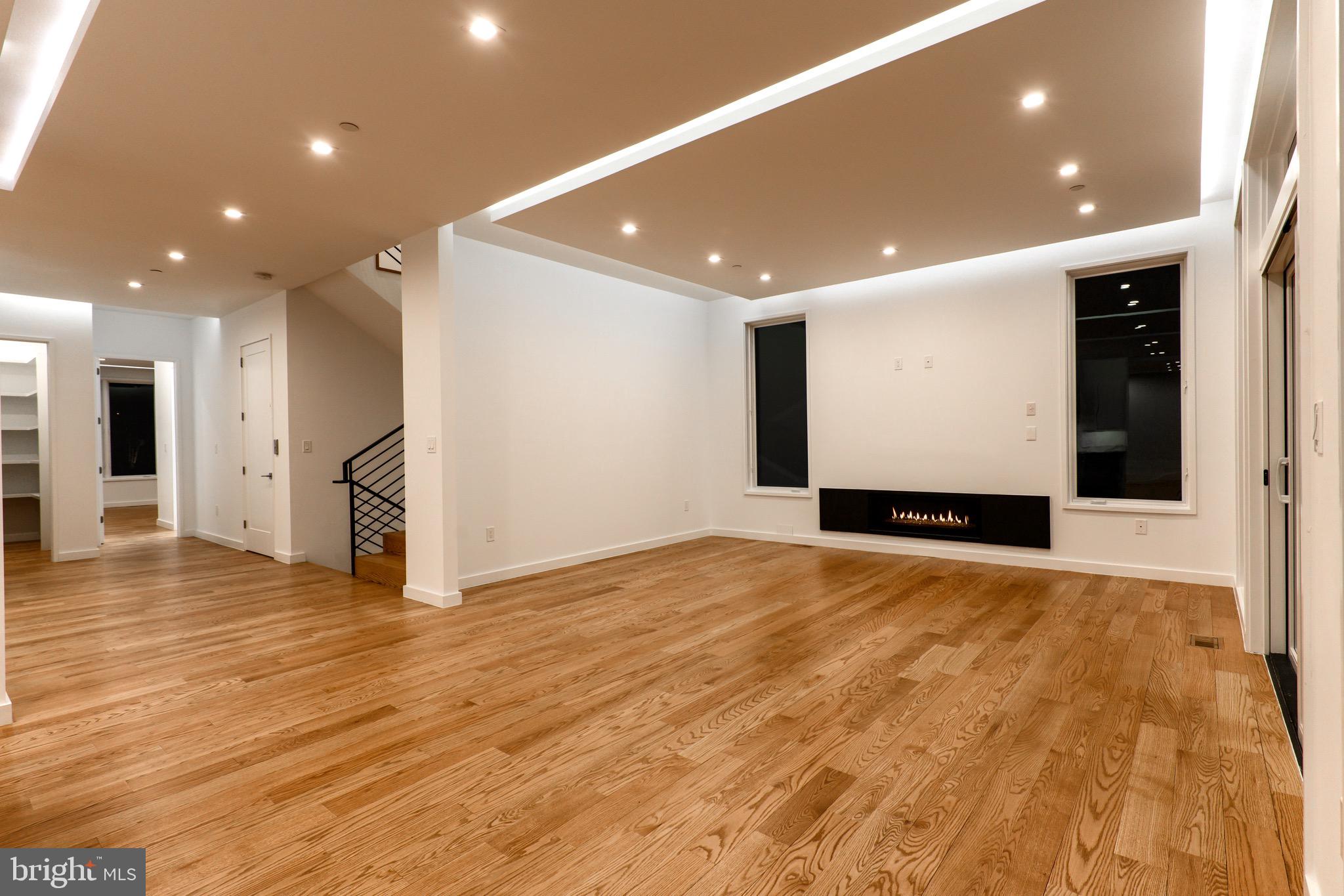 6210 Wedgewood Road Bethesda, MD 20817 - Photo 6 of 60 Spacious family room with Glass Fire-night photo