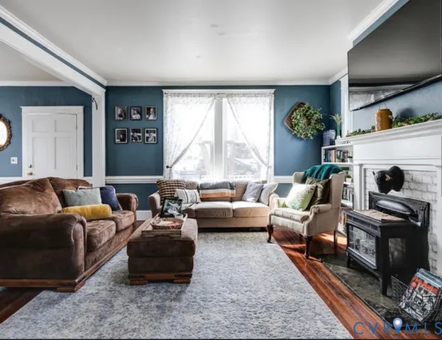 a living room with furniture and a fireplace