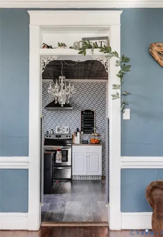 a kitchen with stainless steel appliances kitchen island granite countertop a stove and a sink