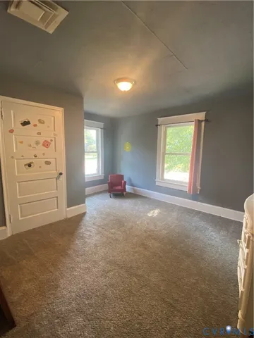 an empty room with windows and closet