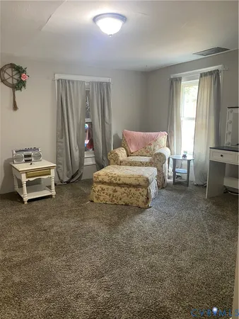 a bedroom with a bed and a chair