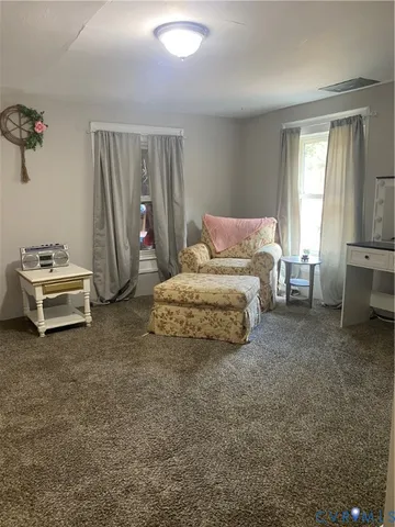 a bedroom with a bed and a chair