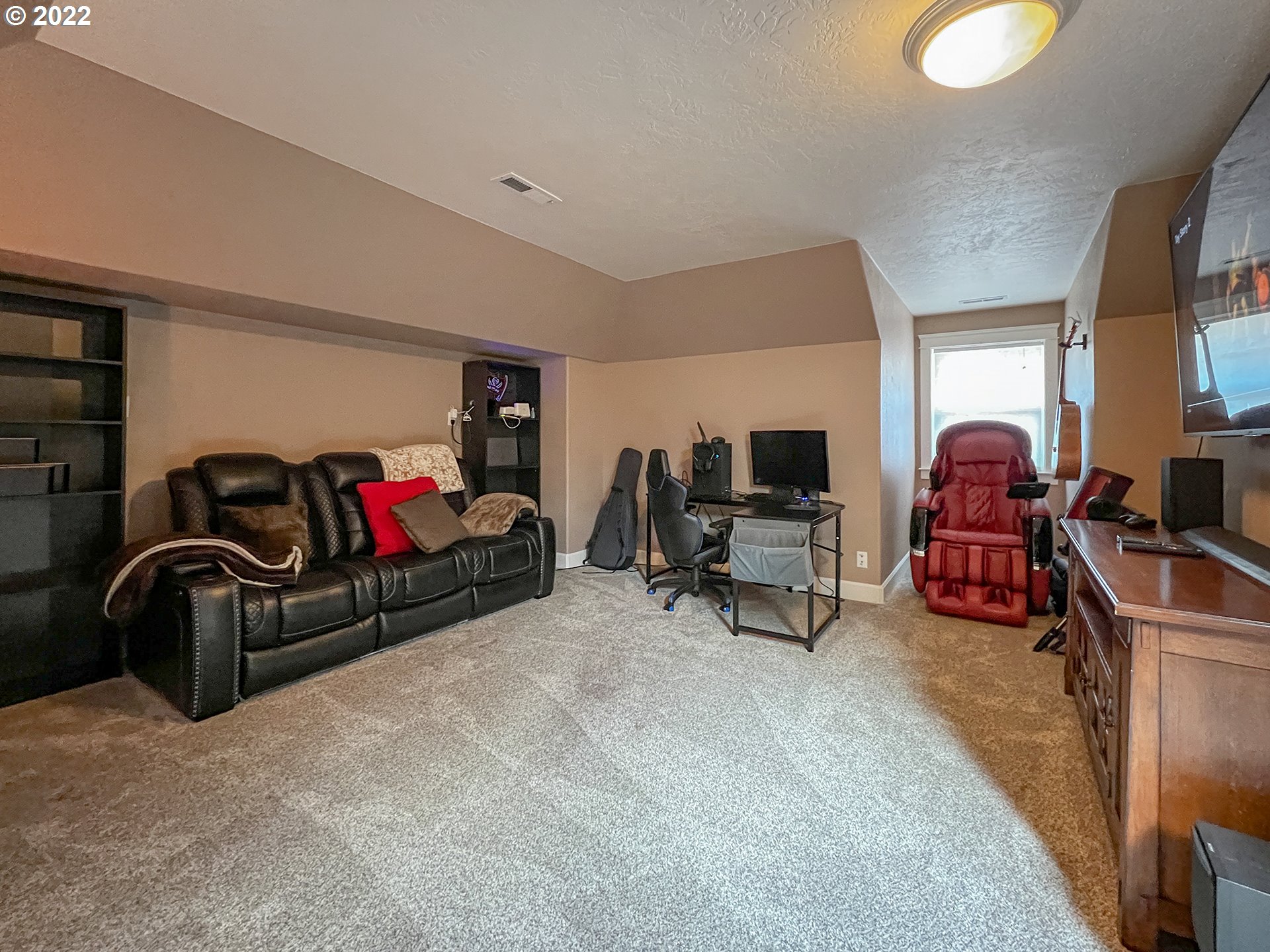 2258 33rd Street Springfield, OR 97477 - Photo 20 of 32 a living room with furniture gym equipment and a flat screen tv