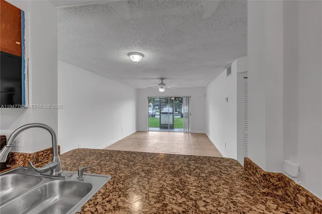 a view of a kitchen sink and a window