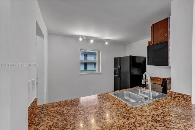 a bedroom with a bed and a television