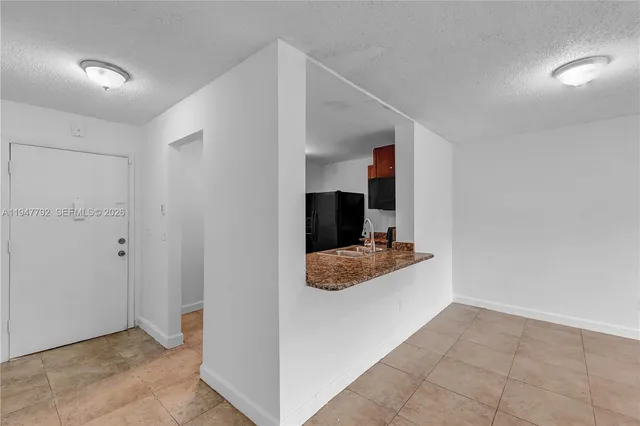 a living room with stainless steel appliances and chandelier