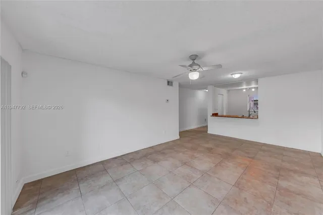 a view of a livingroom with a ceiling fan and window