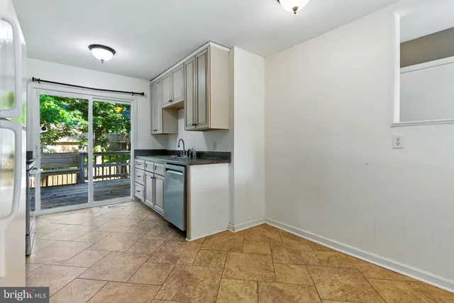 a kitchen with a stove a sink and a refrigerator