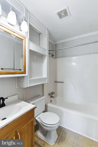 a bathroom with a sink a toilet and bathtub