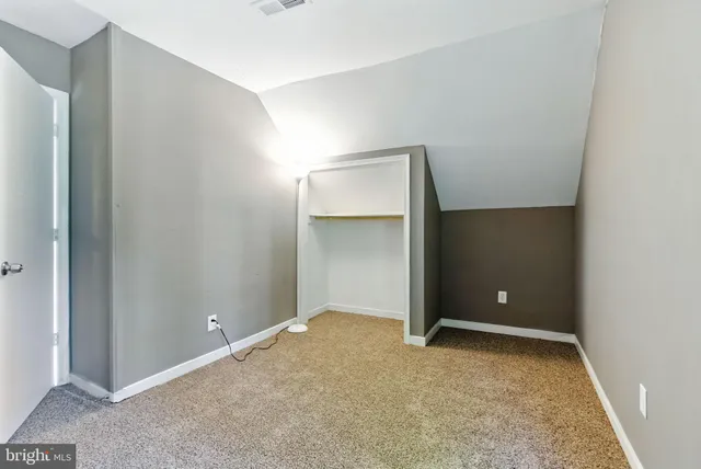 an empty room with closet area