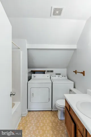 a view of a balcony with wooden floor and fence