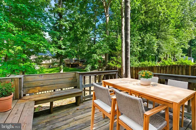 a view of deck with two chairs and wooden fence