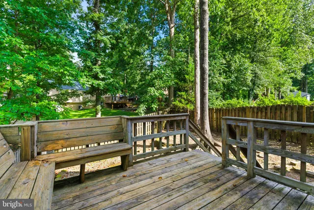 a view of a wooden deck with a yard