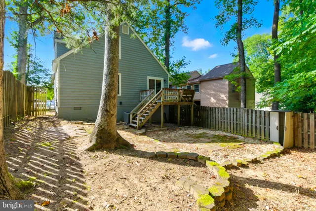 a view of a wooden fence with large trees and wooden fence