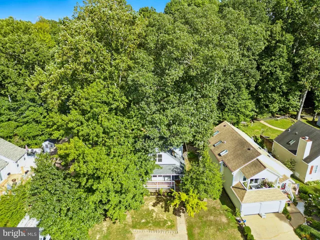 an aerial view of a house with a yard basket ball court and outdoor seating