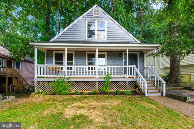 a front view of a house with a yard and porch