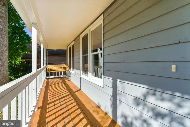 a view of balcony with wooden floor and seating space