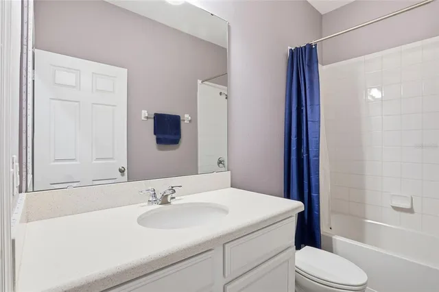 a bathroom with a sink toilet vanity and shower